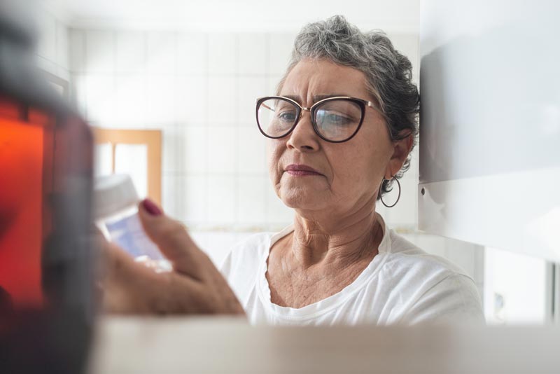 Woman looking at prescription label