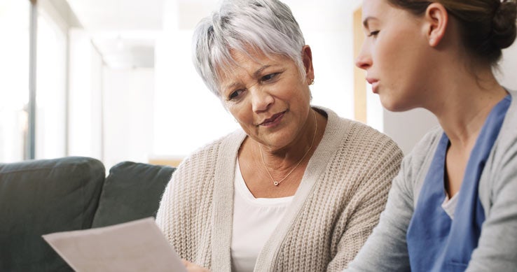 Senior woman reviews results with nurse