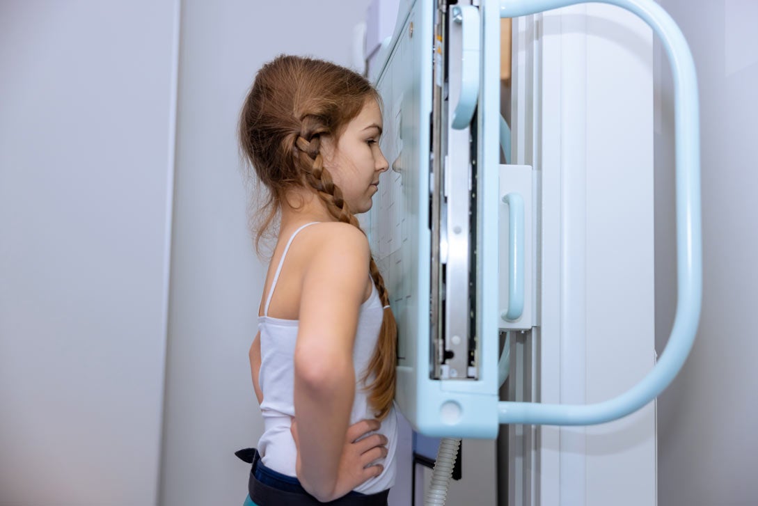 Girl getting a standing chest xray