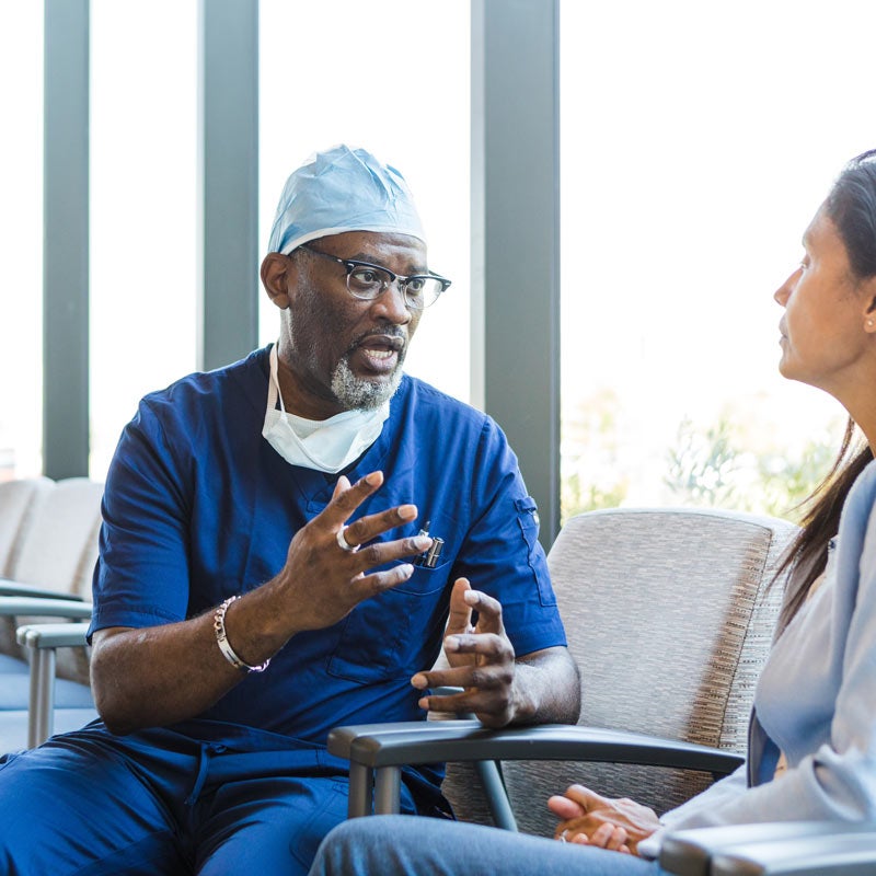 Surgeon talks with female patient