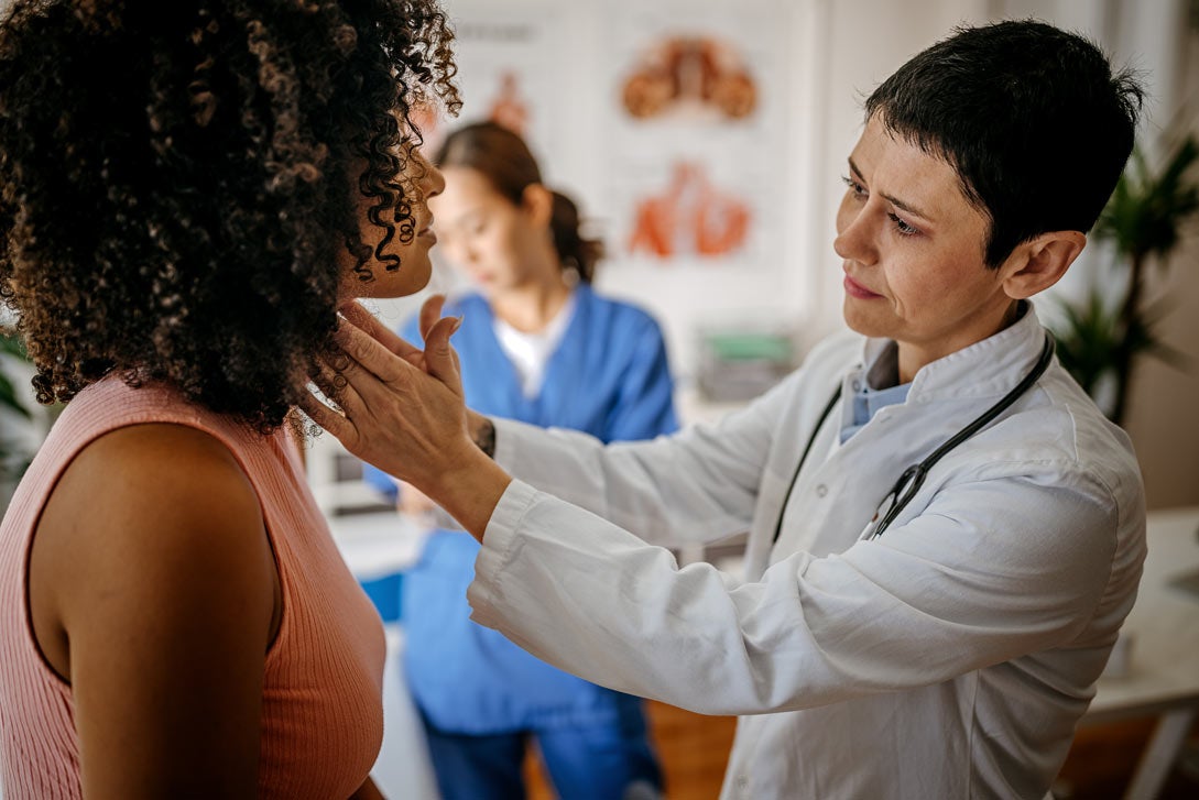 Woman getting a medical exam from doctor